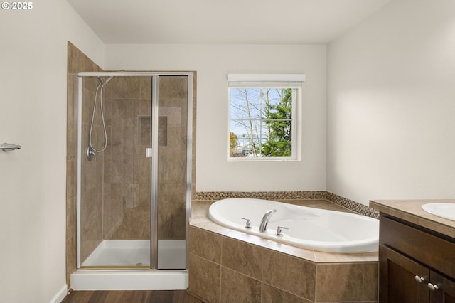 bathroom with vanity, a bath, and a shower stall