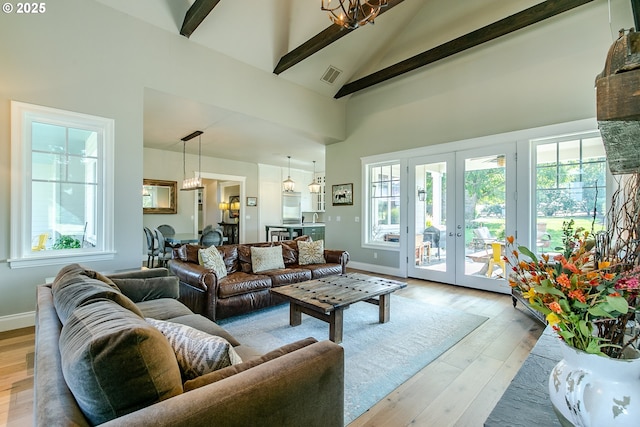 living area with french doors, high vaulted ceiling, visible vents, beamed ceiling, and light wood-style floors
