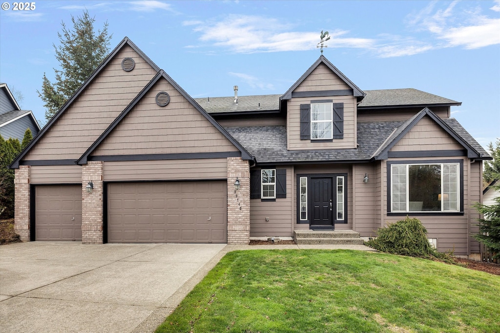 view of front of house with a garage and a front yard