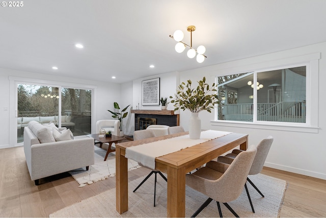 dining room with recessed lighting, baseboards, and light wood-style flooring