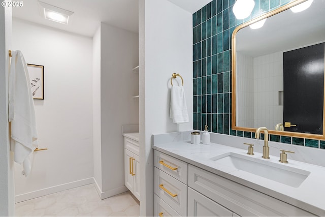 bathroom featuring tile patterned floors, vanity, and baseboards