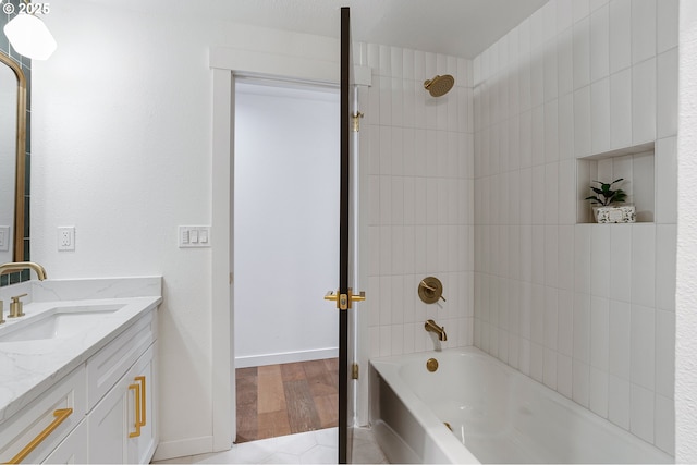 full bath featuring vanity, shower / bathtub combination, and baseboards