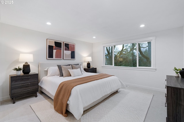 bedroom featuring recessed lighting, light colored carpet, and baseboards