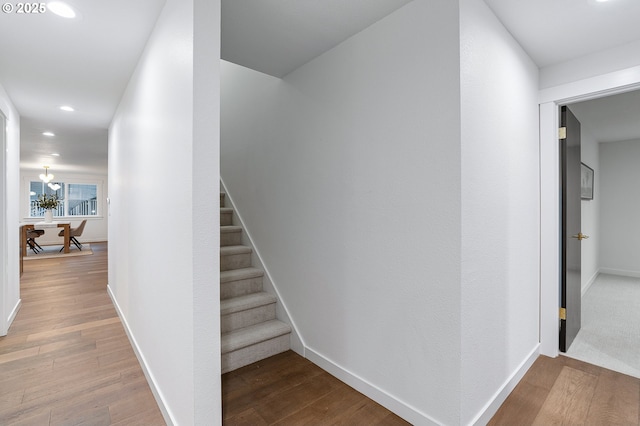 stairs featuring recessed lighting, baseboards, and wood finished floors