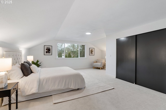 bedroom featuring baseboards, carpet flooring, and vaulted ceiling