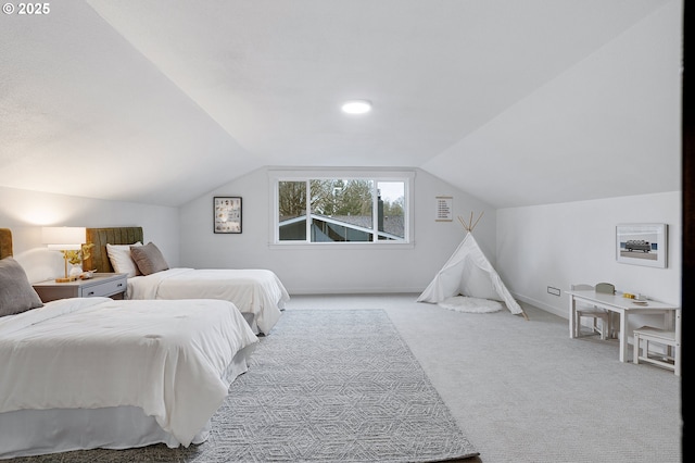 bedroom featuring baseboards, carpet flooring, and vaulted ceiling