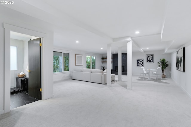 carpeted living area featuring recessed lighting and baseboards