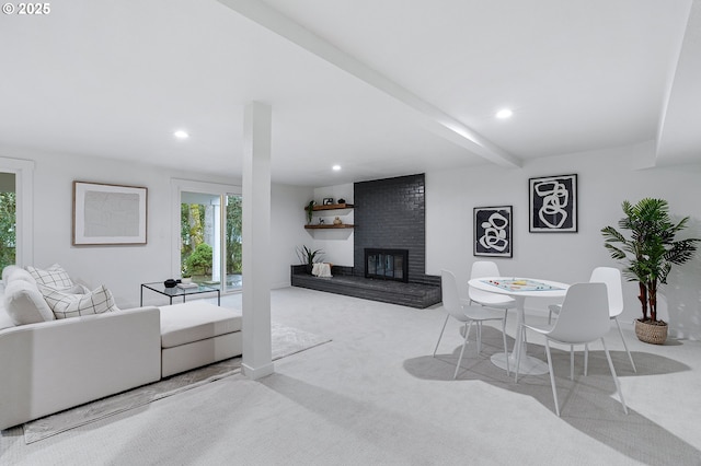 carpeted living area with beam ceiling, recessed lighting, and a brick fireplace