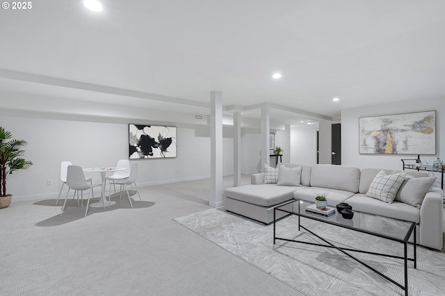 living area featuring recessed lighting, baseboards, and light colored carpet