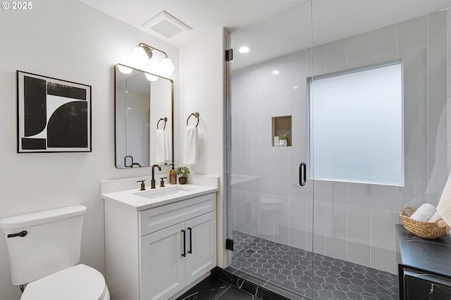 full bath featuring vanity, a shower stall, toilet, and visible vents