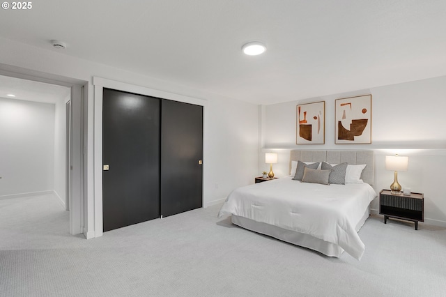 carpeted bedroom with baseboards and a closet