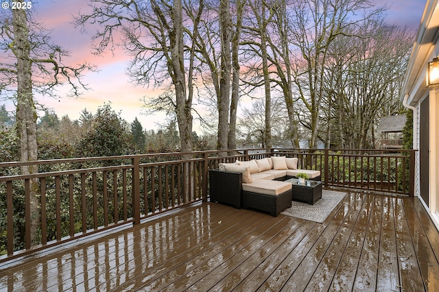 deck at dusk featuring outdoor lounge area