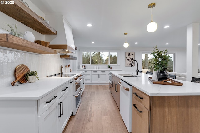 kitchen featuring open shelves, double oven range, a sink, backsplash, and dishwasher