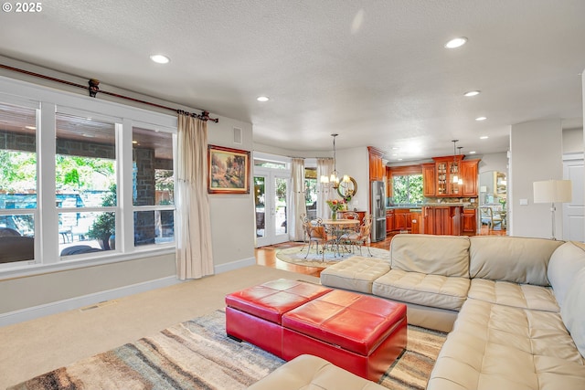 9459 SE Tarnahan Dr, Happy Valley, OR 97086 - living room featuring a chandelier, recessed lighting, baseboards, light carpet, and a textured ceiling