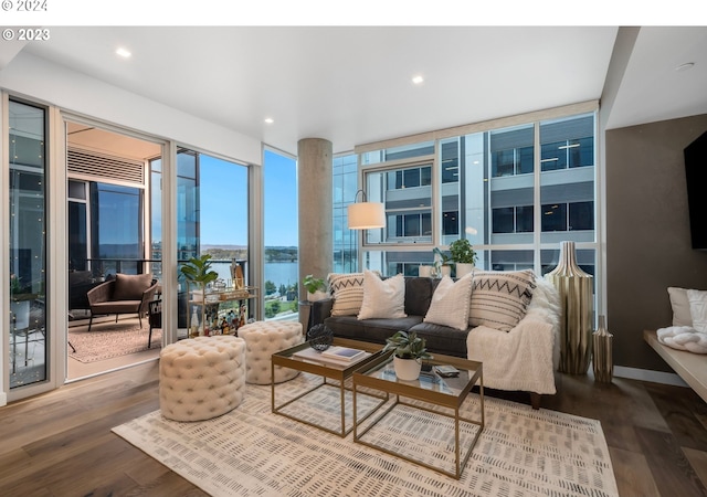 living room featuring recessed lighting, expansive windows, baseboards, and wood finished floors