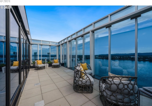 unfurnished sunroom with a water view