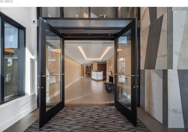 corridor featuring french doors and tile patterned flooring