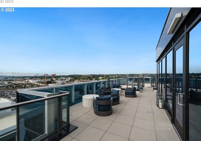 view of patio featuring a view of city and a balcony