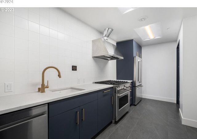 kitchen with a sink, exhaust hood, light countertops, decorative backsplash, and high end appliances