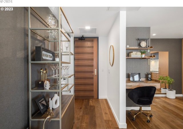 office area with recessed lighting, wood finished floors, baseboards, and built in desk