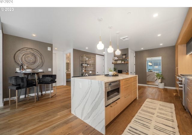 kitchen featuring visible vents, oven, wood finished floors, stainless steel range, and modern cabinets