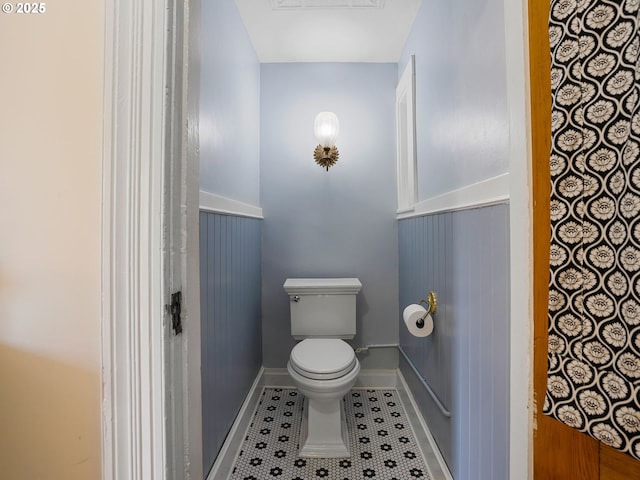 131 NE Tillamook St, Portland, OR 97212 - bathroom featuring toilet, tile patterned flooring, and a wainscoted wall