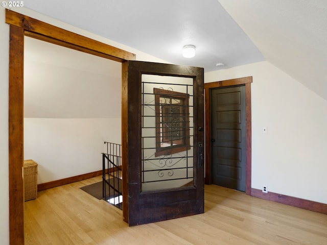 131 NE Tillamook St, Portland, OR 97212 - entryway featuring wood finished floors, vaulted ceiling, and baseboards
