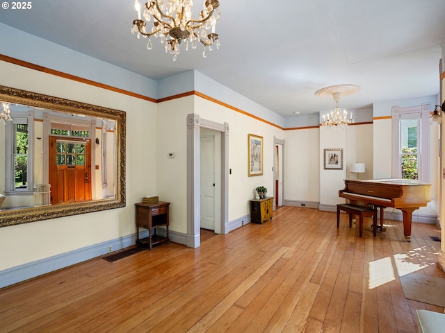 131 NE Tillamook St, Portland, OR 97212 - foyer entrance with a chandelier, light wood-style flooring, and baseboards