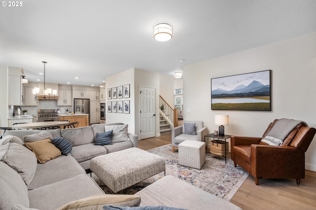 living room with light hardwood / wood-style floors and sink