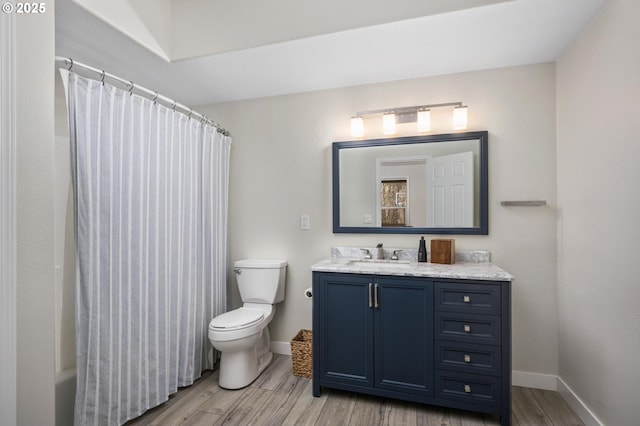 bathroom featuring wood-type flooring, vanity, and toilet