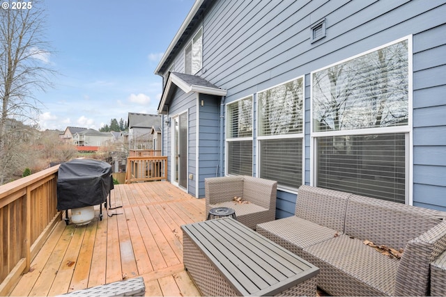 deck featuring an outdoor living space and area for grilling