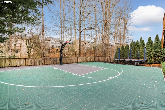 view of basketball court with a trampoline