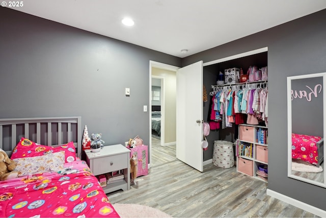 bedroom with hardwood / wood-style flooring and a closet