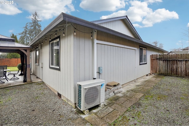 view of home's exterior featuring a gazebo, a patio, and ac unit