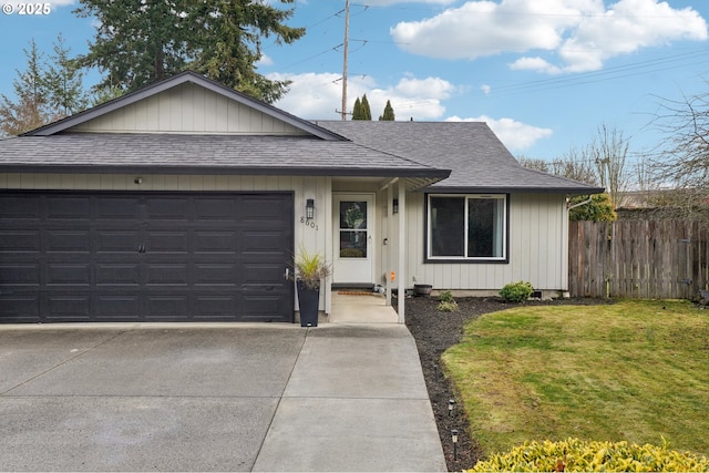 ranch-style house featuring a garage and a front yard