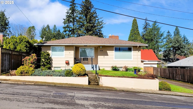 view of front of property with a chimney and fence