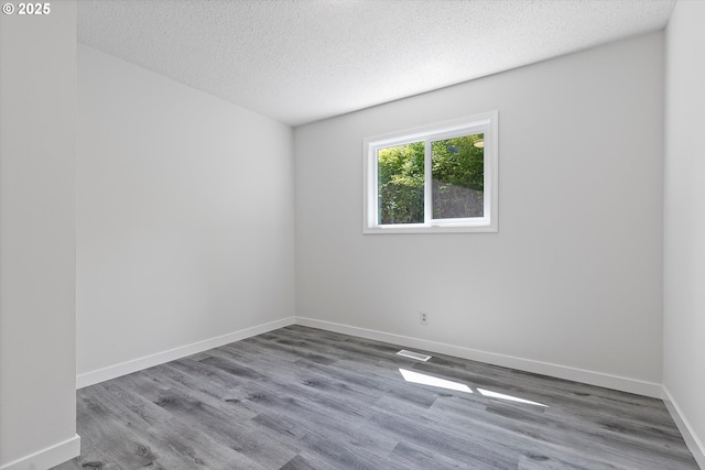 245 NE 4th Ave, Hillsboro, OR 97124 - spare room featuring wood finished floors, a textured ceiling, and baseboards