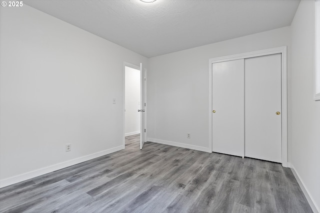 245 NE 4th Ave, Hillsboro, OR 97124 - unfurnished bedroom featuring wood finished floors, baseboards, and a closet