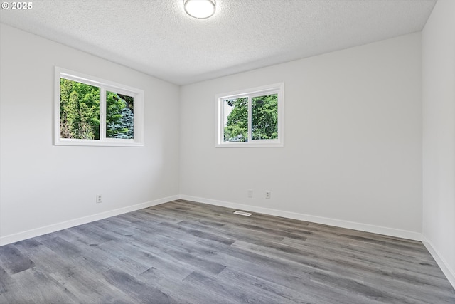 245 NE 4th Ave, Hillsboro, OR 97124 - unfurnished room featuring wood finished floors, baseboards, and a textured ceiling