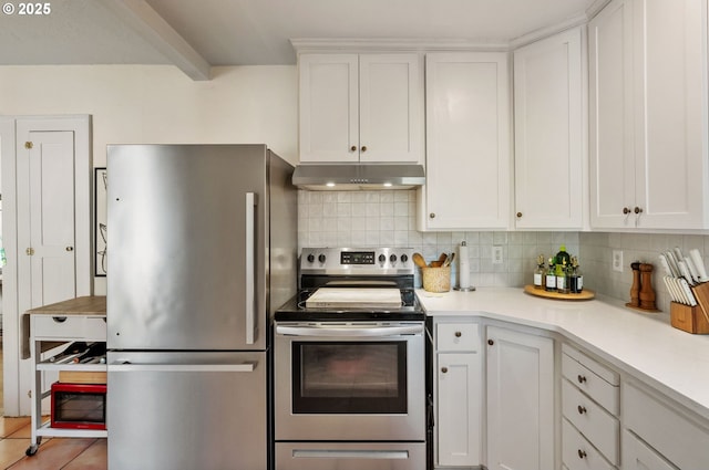 909 NE Brazee St Unit 16, Portland, OR 97212 - kitchen with stainless steel appliances, under cabinet range hood, decorative backsplash, and white cabinetry