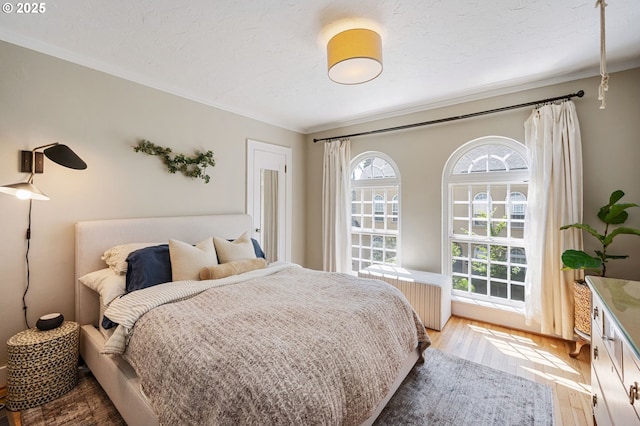 909 NE Brazee St Unit 16, Portland, OR 97212 - bedroom with light wood-style floors, radiator, and ornamental molding