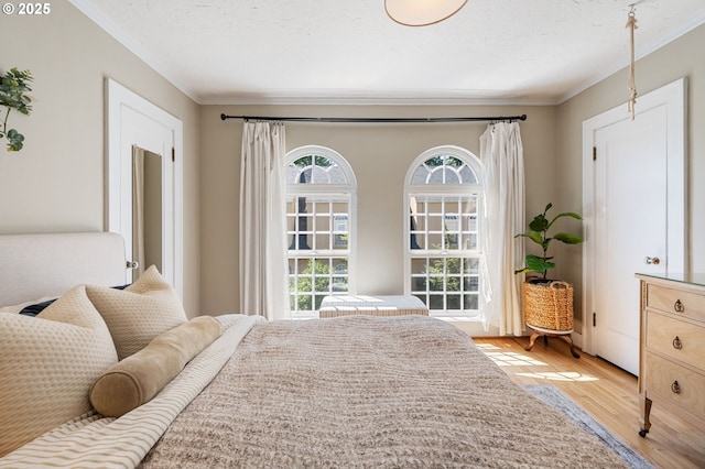 909 NE Brazee St Unit 16, Portland, OR 97212 - bedroom with crown molding, light wood-type flooring, and multiple windows