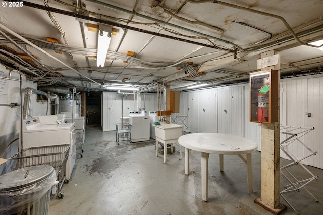 909 NE Brazee St Unit 16, Portland, OR 97212 - unfinished basement featuring washing machine and dryer and a sink