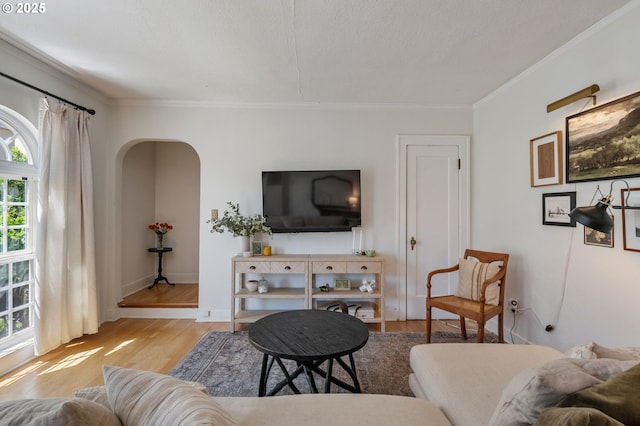 909 NE Brazee St Unit 16, Portland, OR 97212 - living room with wood finished floors, arched walkways, and crown molding