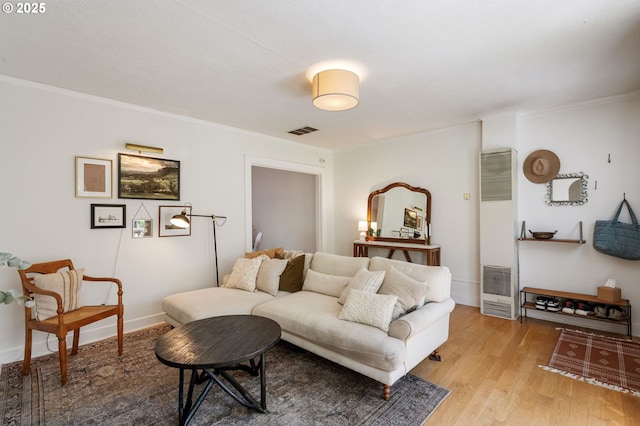 909 NE Brazee St Unit 16, Portland, OR 97212 - living room featuring a heating unit, light wood-style floors, and ornamental molding