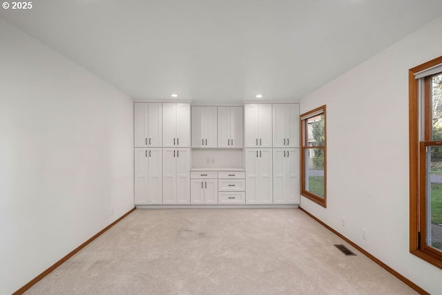 carpeted spare room featuring plenty of natural light