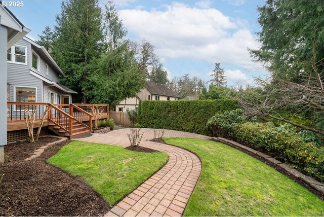 view of yard featuring a patio area and a deck