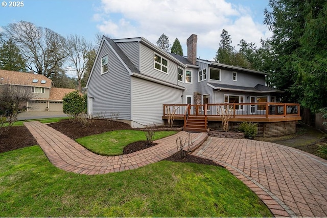 back of house with a lawn and a deck