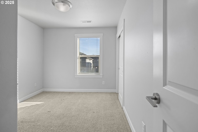 unfurnished bedroom with carpet floors, a closet, visible vents, and baseboards