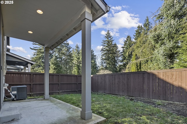 view of yard featuring central AC unit, a patio area, and a fenced backyard